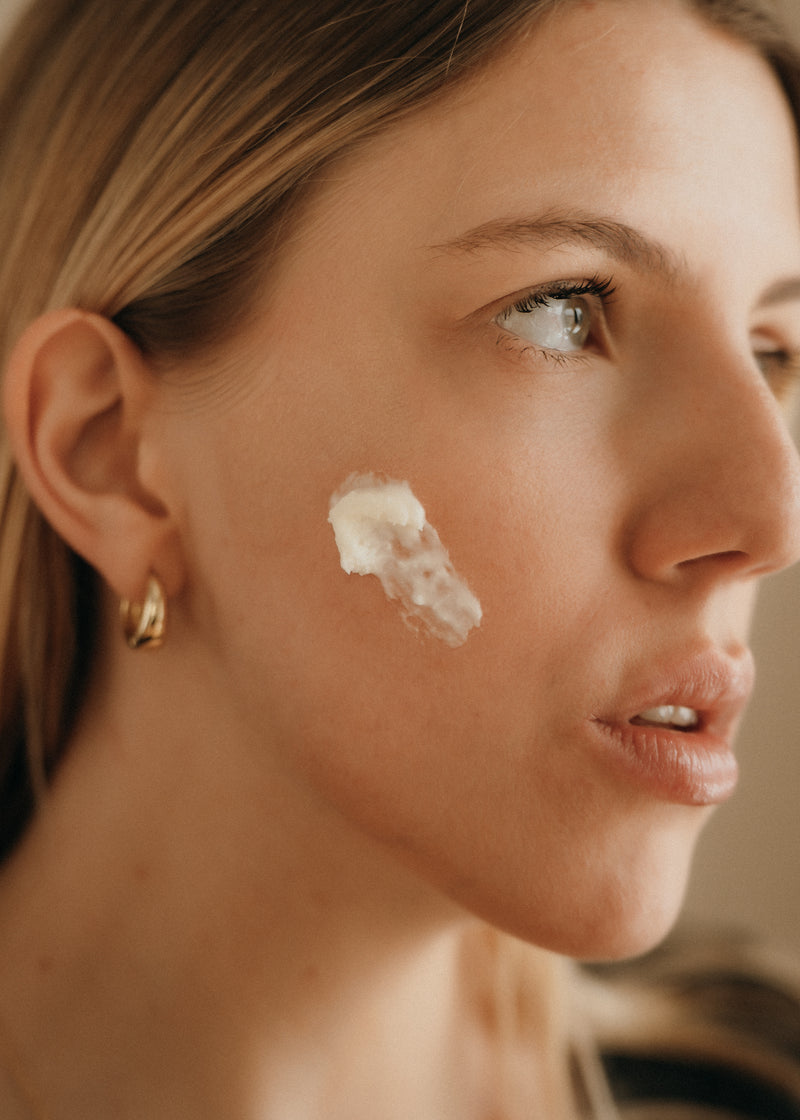 Face Balm being pressed into a cheek